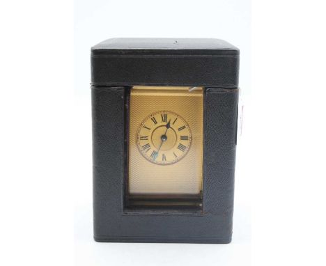 An early 20th century brass cased carriage clock, the gilt chapter ring showing Roman numerals, the movement having visible p