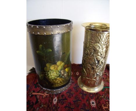 An embossed brass stick stand and a papier-mâché stick stand with painted decoration 