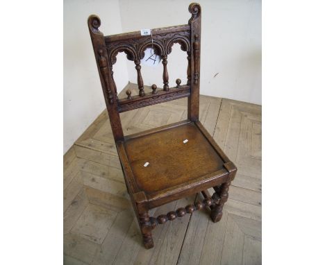 Early 19th C oak solid seat chair with triple arch panel back, on turned bobbin front supports 
