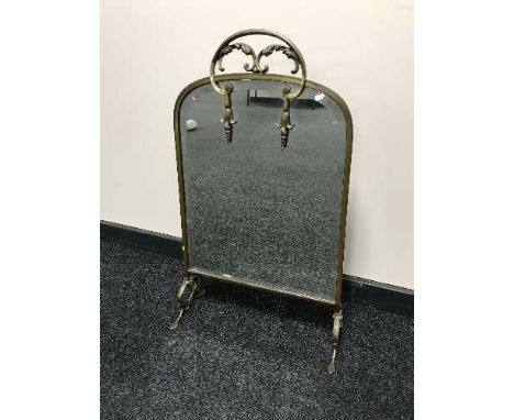 An early 20th century brass mirrored fire screen