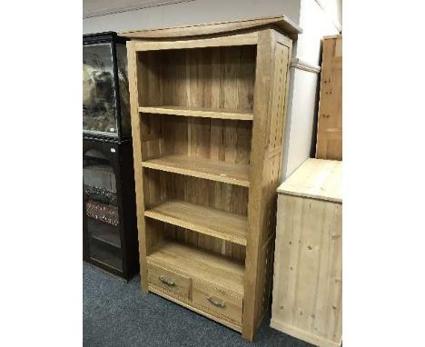 A light oak open bookcase fitted with drawers