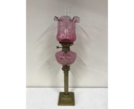 A brass Corinthian column oil lamp with pink glass shade, Hinks Lever No. 2 