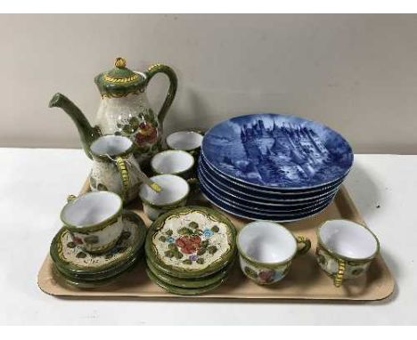 A tray containing a thirteen-piece pottery tea service together with a set of seven West German blue and white wall plates