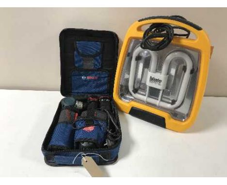 A Bosch Professional cordless screwdriver in case and a Defender site light 
