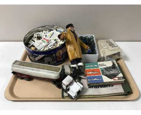 A tray containing assorted tea cards, vintage marbles, Corgi oil tanker