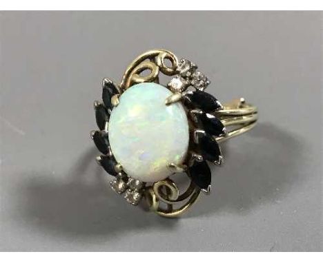 A sapphire and diamond ring set with a large opal 