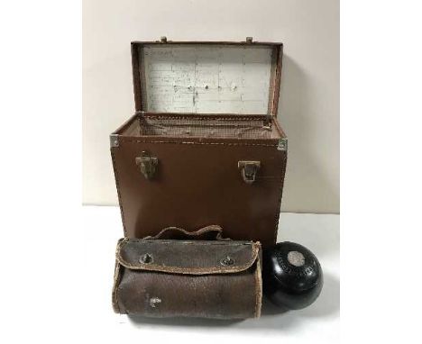 A leather record box containing six vintage wooden lawn bowls