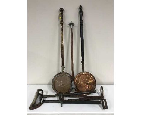 Two copper bed warming pans, shooting stick and two stirrup pumps 