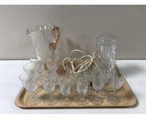 A tray of assorted glassware including a vintage glass table lamp, glass water jug, assorted drinking glasses