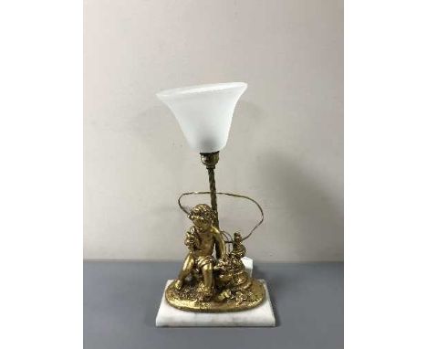 A gilt cherub table lamp