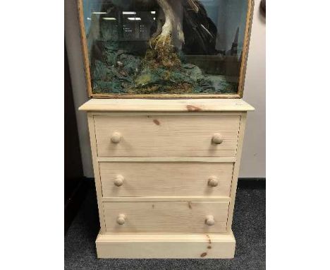 A light pine three drawer chest