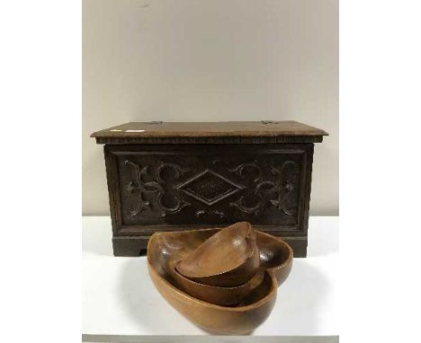 A pine box with carved oak panel containing wooden bowls, music boxes etc 