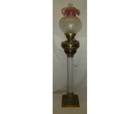 A large 20th Century brass mounted oil lamp with opaque glass column stem and etched shade, 36" high