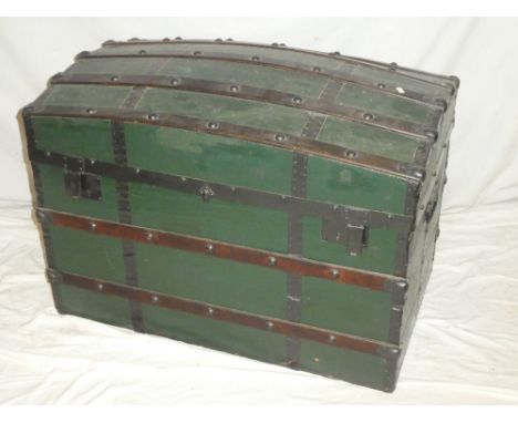 An old domed travelling trunk with wooden ribbed top