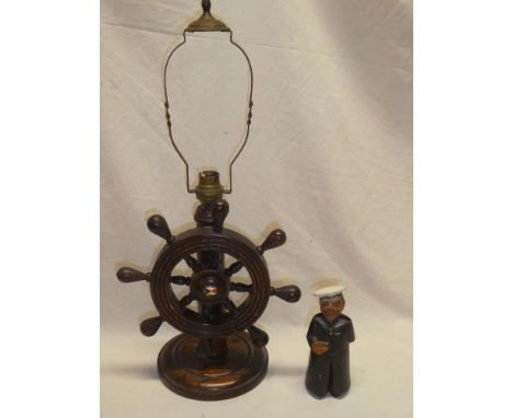 A 1930's oak ship's wheel table lamp, the centre with enamelled badge "SS Strathaird" and a carved and painted wood sailor bo