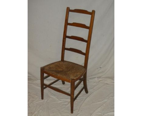 A beech country-style ladder-back occasional chair with rush-work seat on tapered legs