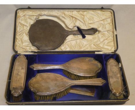 A George V silver-mounted six-piece dressing set comprising a pair of hair brushes, a pair of clothes brushes,  hand mirror a