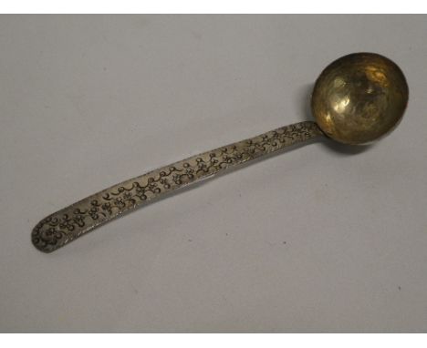 A Middle Eastern beaten silver ladle with incised decoration