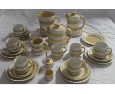 A selection of T.G. Green Gold striped Cornish kitchen ware modelled by Judith Onions including quart measuring jug, hot wate