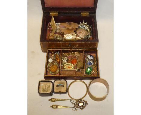 A leather jewellery box containing a quantity of Victorian and later costume jewellery including brooches, earrings, turquois