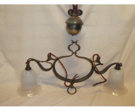 An Arts and Crafts brass rise-and-fall twin branch ceiling light with vaseline-tinted glass shades