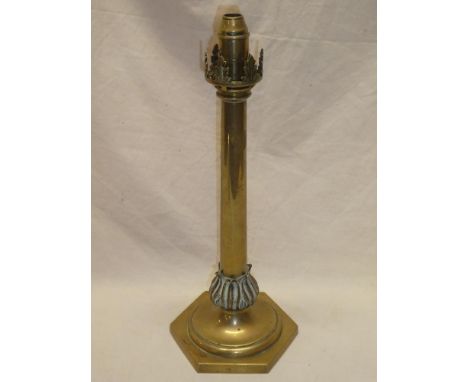 A 19th century brass rise-and-fall candle-lamp with tapered stem and hexagonal base 17" high