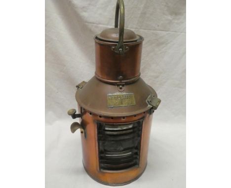 A brass mounted copper ship's Meteorite hand signalling lamp with original oil fitment 16½" high overall