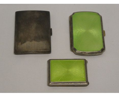 A silver rectangular concave cigarette case with engine turned decoration, plated cigarette case with green enamel decoration