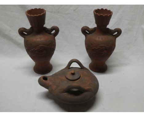 A pair of Eastern terracotta tapered vases with dragon decorated handles, 10" high and one other terracotta Roman-style oil l