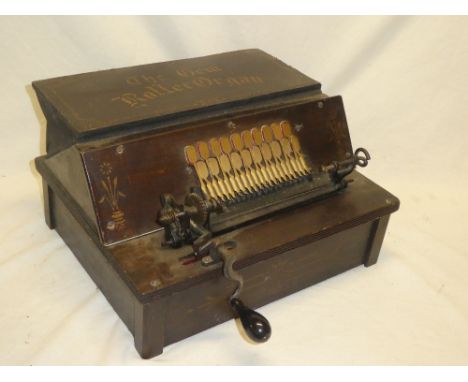 An unusual old Gem roller organ in stained wood painted case