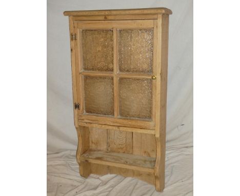 A 19th Century polished pine wall mounted cupboard with shelves enclosed by a glazed door above an open shelf