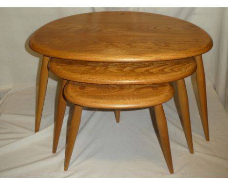 A nest of Ercol light elm "Pebble" tea tables on tapered legs