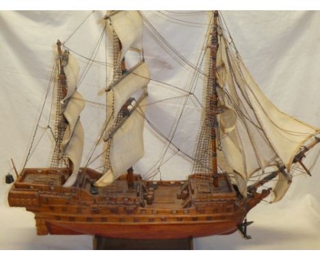 An old wooden scale built two-masted sailing boat with linen sails and deck detail 31" long and one other similar wooden scal