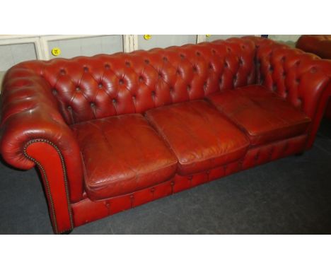 A good quality three seat Chesterfield sofa upholstered in red buttoned leather together with a matching red buttoned leather