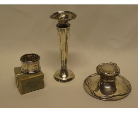 A small silver capstan-style inkwell with hinged lid, Birmingham marks, silver tapered spill vase and a boxed silver napkin r