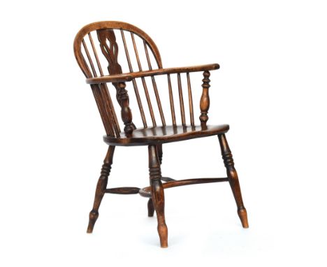 A splat back Windsor chair, turned front arm supports, the elm saddle seat raised on ring turned legs and crinoline stretcher