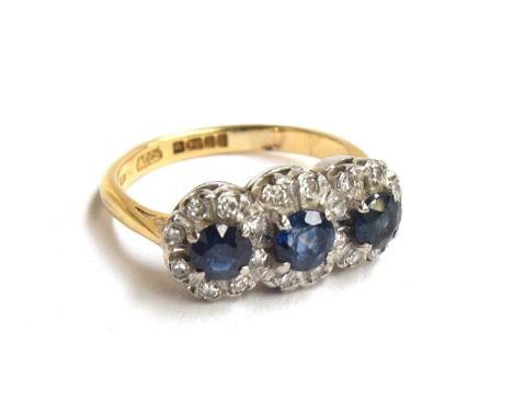 An 18ct gold, sapphire and diamond triple cluster ring, hallmarked 'Albion', size K, approx. 4.2g, in box