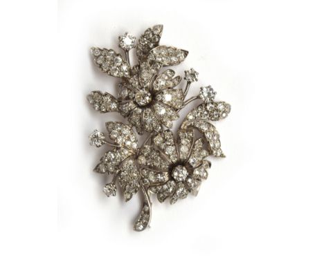 A French Belle Epoque diamond and platinum brooch in a floral form, set with approx. 184 diamonds, the largest diamond approx