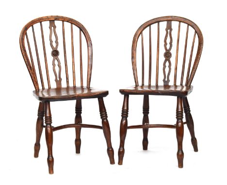 A pair of yew and elm Windsor side chairs, attributed to the Prior Family workshop, narrow pierced and roundel splat, the sad