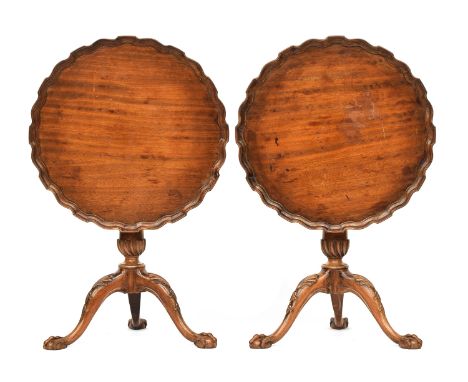 A pair of George II style mahogany tripod tables, each with shaped pie crust tilt top on a gun barrel stem with spiral bowl, 