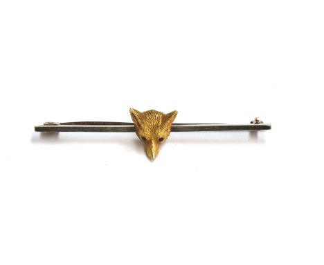 A 14ct gold fox mask, set with ruby eyes, mounted on a white metal bar brooch, 5.8cm wide, approx. 5.4g 