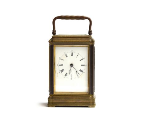 A gilt metal carriage clock with bevelled glass panels and enamel dial with Roman numerals, 16.5cm high 
