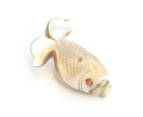 A 19th century Japanese mother of pearl netsuke in the form of a fish, set with coral eye, 4cm long 