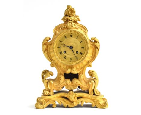 A 19th century French Ormolu mantel clock, the gilt dial with Roman Numerals signed 'Huguenin A Paris' with an eight day two 