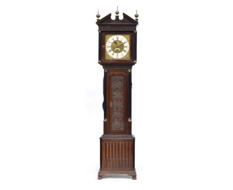 An oak longcase clock, broken pediment over blind fretwork, the 12.5" dial with white enamel chapter ring, Roman hours and Ar