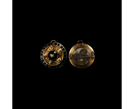 Dated 1864 AD. A large gold memorial brooch, the front inscribed 'IN MEMORY OF' in Black Letter reserved against black enamel