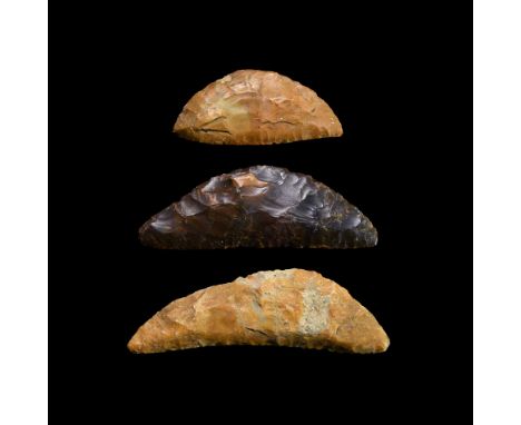 Neolithic, 6th-3rd millennium BC. A group of three finely knapped bifacial flint sickle knives, each with one straight edge a