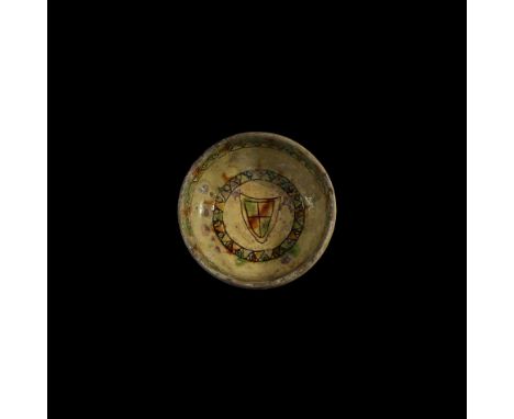 12th-early 13th century AD. A ceramic sgraffito bowl with squat carinated body, short waisted stem and flared foot; cream and