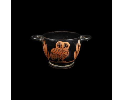4th century BC. A red-figures skyphos, decorated on each side with an owl standing between two sprays of olive, the owl’s bod