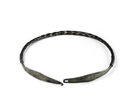 9th-12th century AD. A silver neck-ring comprising a tapering round-section shank with dimple detailing, applied silver-wire 